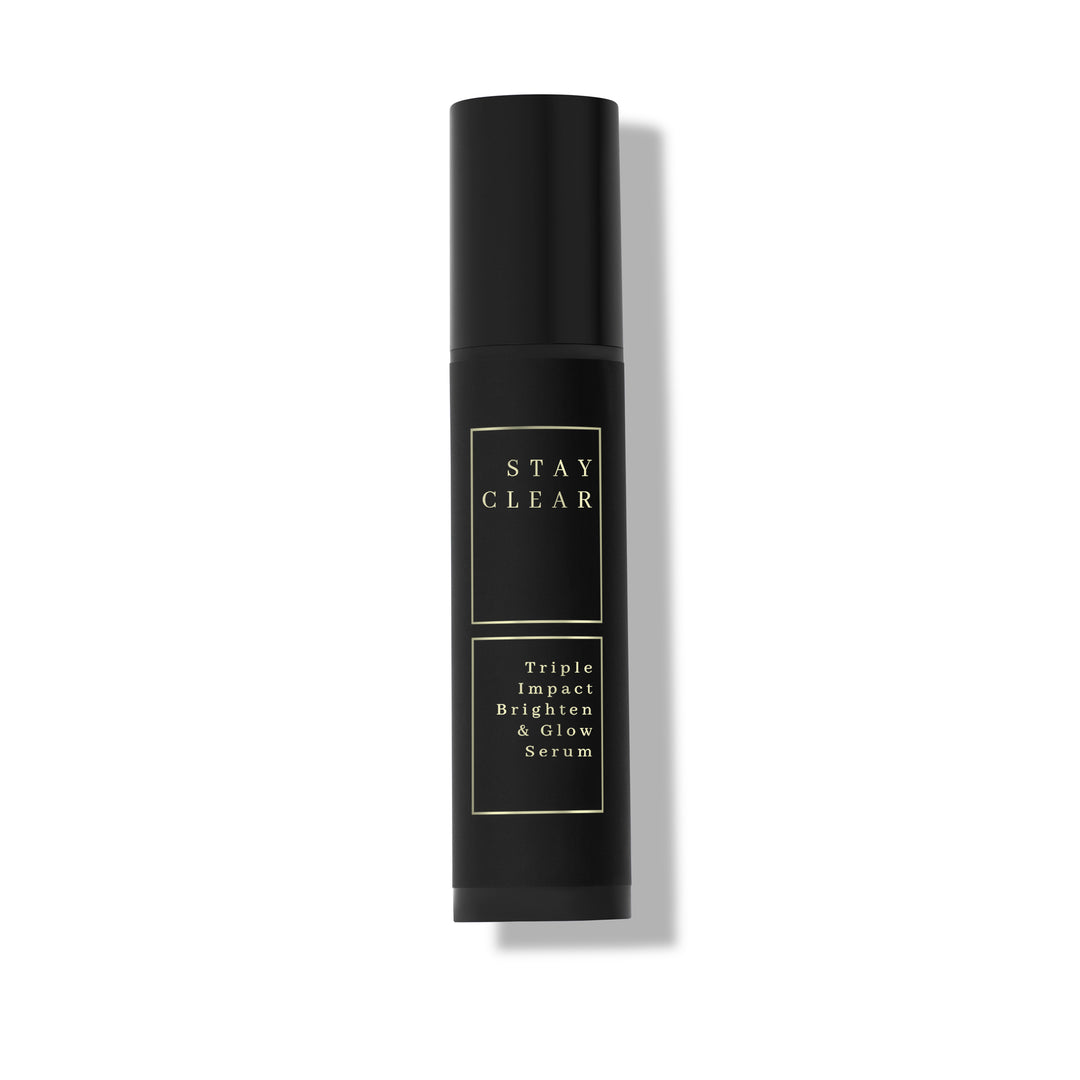 Stay Clear Beauty Triple Impact Brighten &amp; Glow Serum dark airless pump bottle on neutral background — clinical brightening serum for dark spots and uneven skin tone.