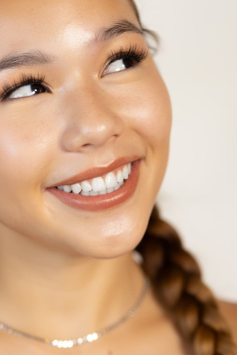 Woman smiling with clear, glowing skin — Stay Clear Beauty Acne Kit for Breakouts and Bumps for active pimples, inflamed acne, and acne-prone skin.