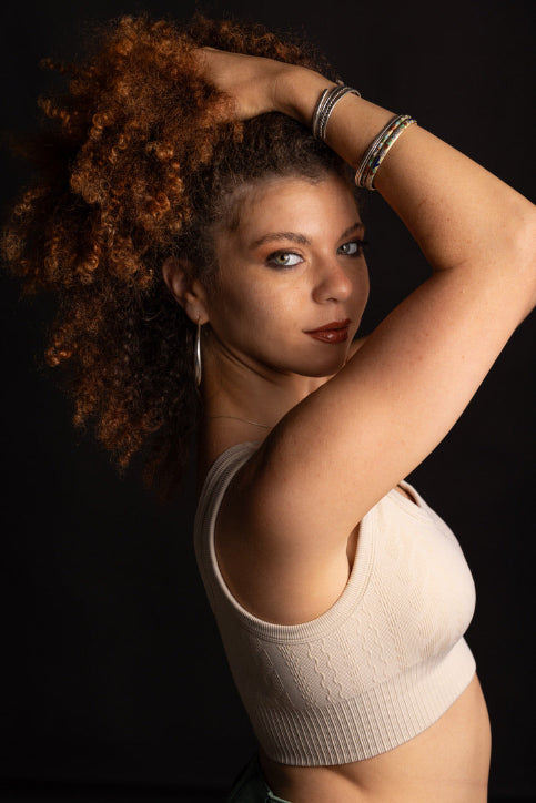 Woman with curly auburn hair and healthy, clear skin — Stay Clear Beauty A Barrier First Kit for reactive, sensitive, and acne-prone skin barrier repair.
