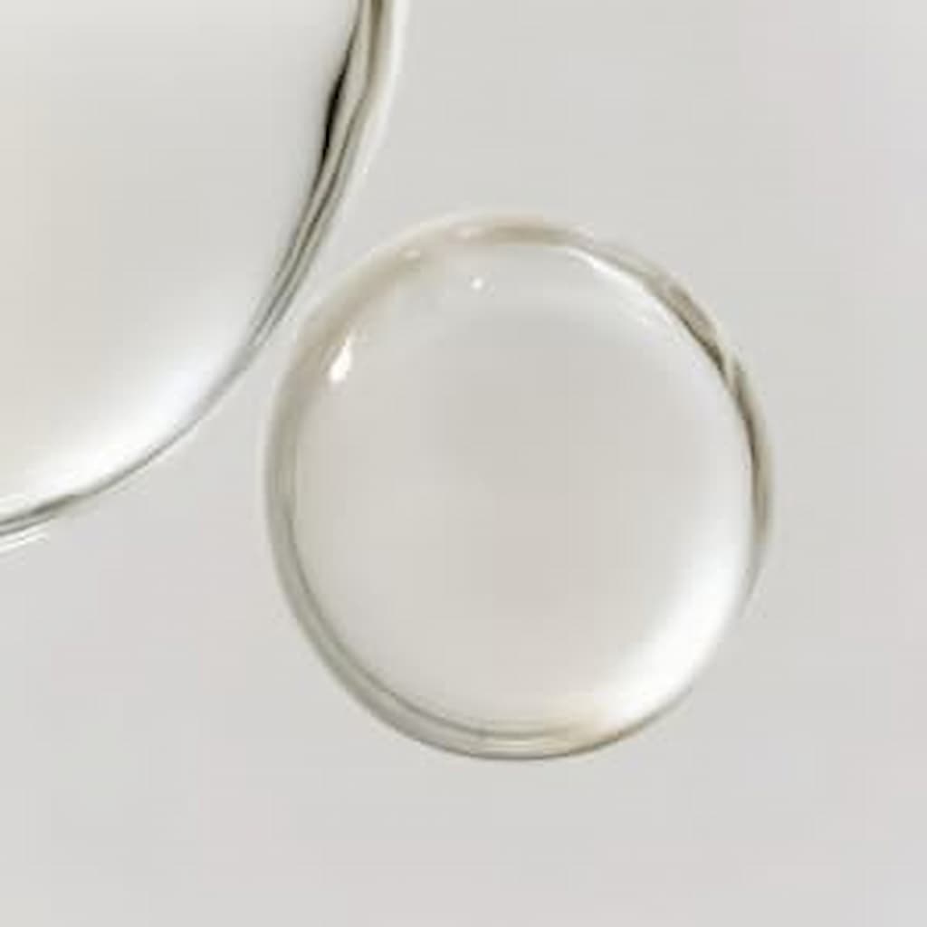 A pump of Stay Clear Beauty Deep Dive Hydration Serum on a flat surface showing its lightweight, clear gel texture — hydrating serum for dehydrated skin, acne-prone skin, and compromised skin barrier.
