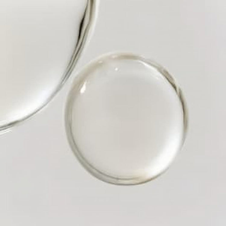 A pump of Stay Clear Beauty Deep Dive Hydration Serum on a flat surface showing its lightweight, clear gel texture — hydrating serum for dehydrated skin, acne-prone skin, and compromised skin barrier.
