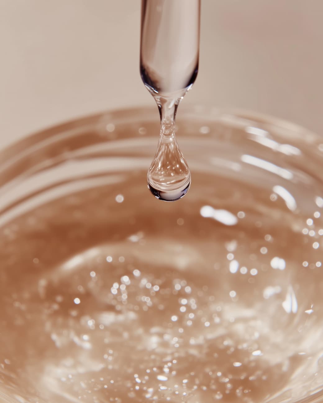 Close-up of Stay Clear Beauty Enduring Radiance Lactic Toner liquid dropping from a pipette — lightweight lactic acid toner for brightening, gentle exfoliation, and sensitive acne-prone skin.
