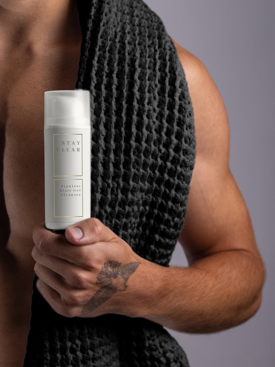 Man holding Stay Clear Beauty Flawless Start Gel Cleanser emphasizing its gentle yet effective formula — sulfate-free gel cleanser for sensitive skin, acne-prone skin, skin barrier repair, and irritation relief.
