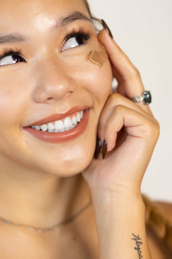 Woman applying Stay Clear Beauty Impact Hydration Moisturizer to face — chaga mushroom barrier moisturizer for dehydrated, sensitive, and acne-prone skin.
