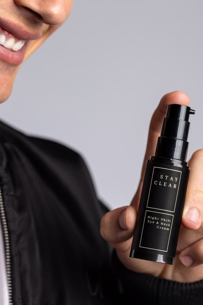 Man holding Stay Clear Beauty Night Shift Eye & Neck Cream highlighting its advanced formula designed to firm and rejuvenate delicate skin — eye cream and neck cream for fine lines, wrinkles, sagging skin, and dark circles.
