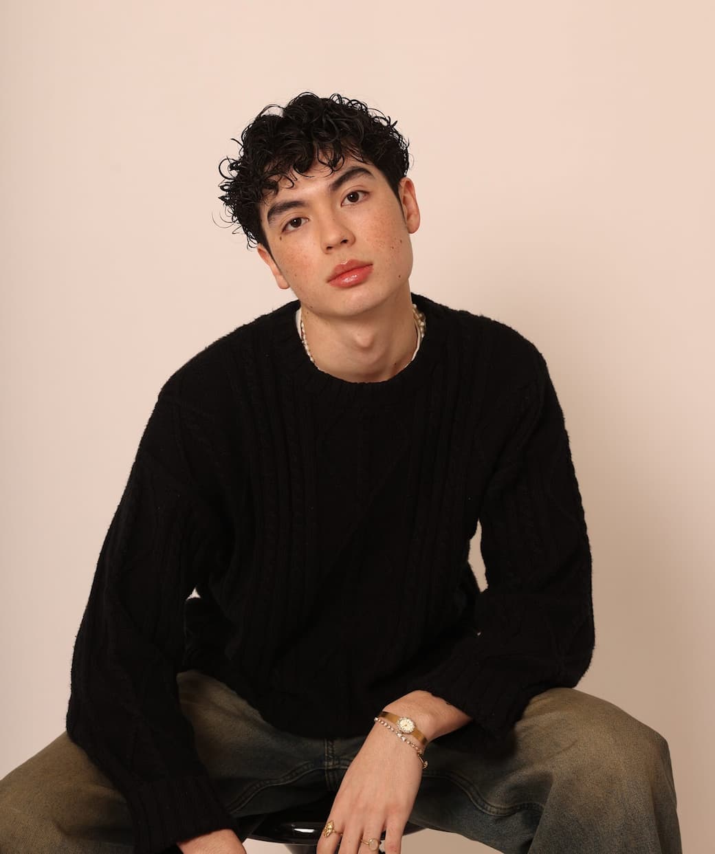 Young man with clear, smooth skin wearing a black sweater — Stay Clear Beauty Overnight Renewal Retinyl retinaldehyde night treatment for skin renewal, fine lines, uneven texture, and acne-prone skin.
