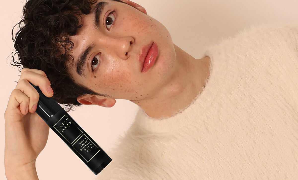 Handsome man with brown hair holding Stay Clear Beauty Triple Impact Hydrating and Glow Serum — hydrating serum for clear, glowing skin

