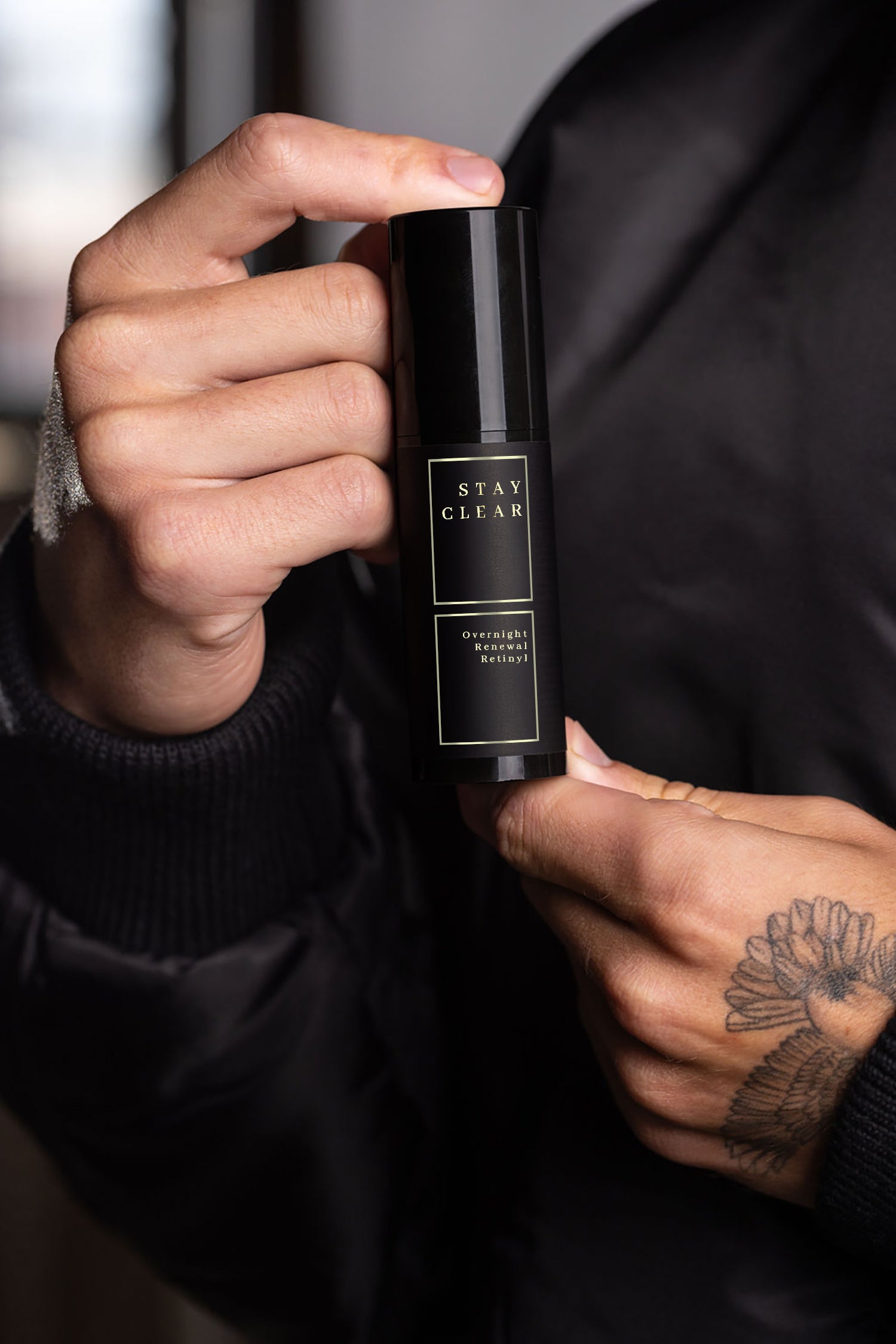 A man holding Stay Clear Overnight Renewal Retinyl, showcasing its advanced retinyl formula designed to rejuvenate and renew the skin overnight for a smoother, more youthful complexion.