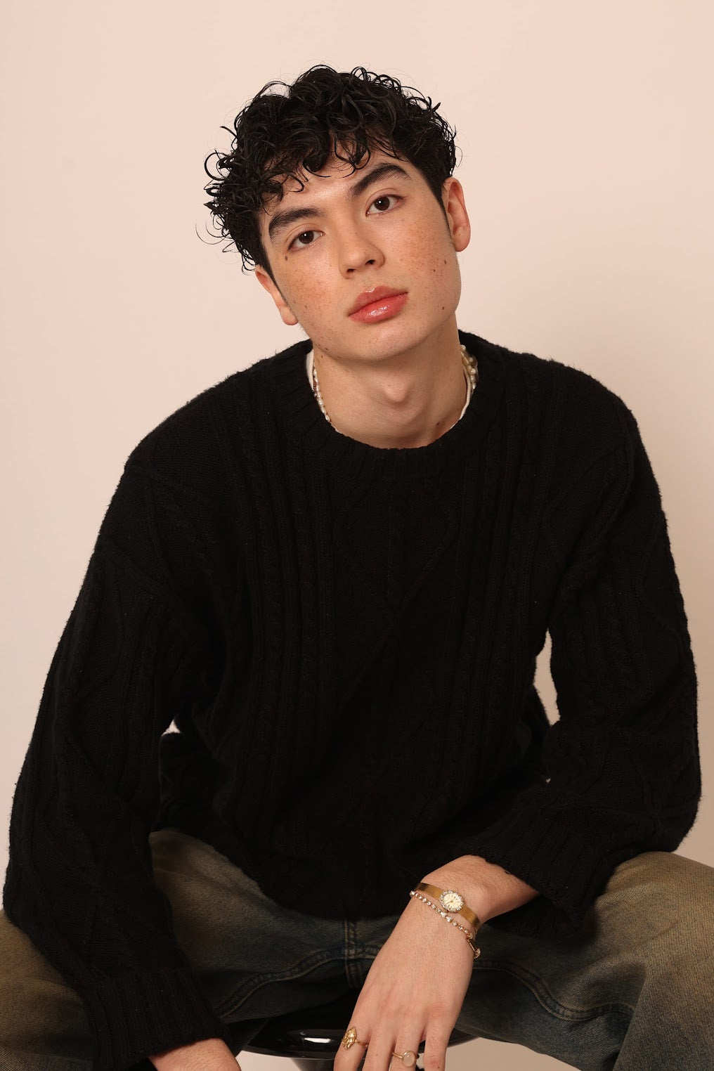 A man sitting comfortably, representing the calm and confidence achieved through using Stay Clear skincare products.