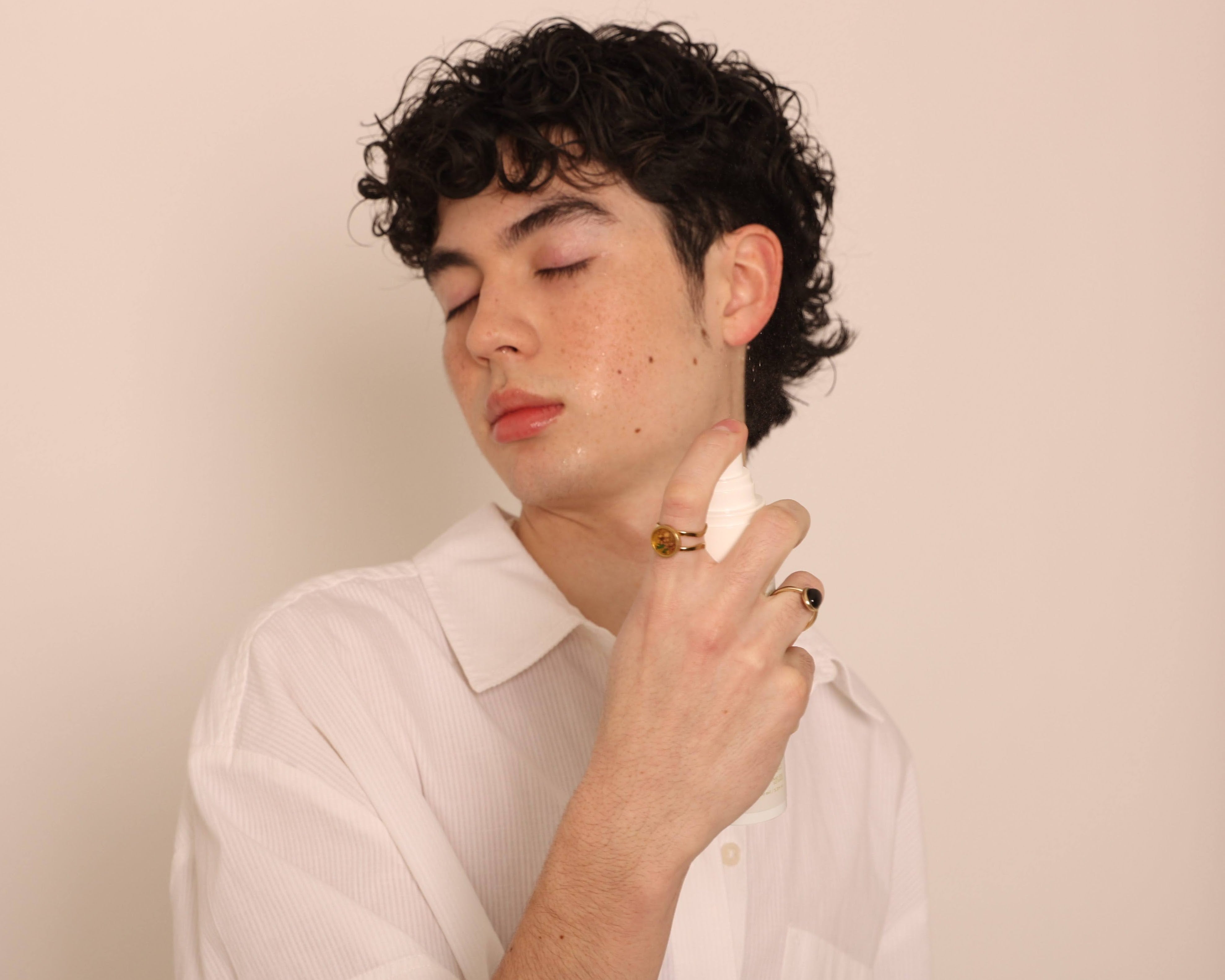 A man spraying Stay Clear Tiger Grass Relentless Hydration Toner, highlighting its refreshing, hydrating, and skin-soothing benefits for sensitive and dry skin.