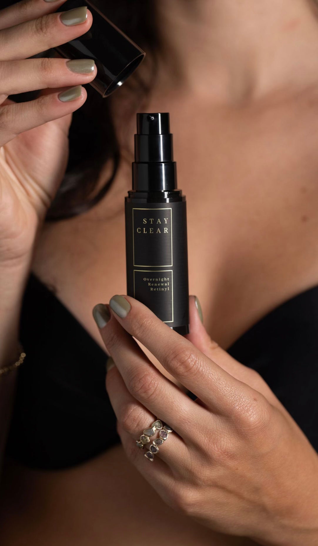 A woman holding Stay Clear Overnight Renewal Retinyl, highlighting its advanced formula designed to rejuvenate and renew the skin overnight for a smoother, more youthful complexion.