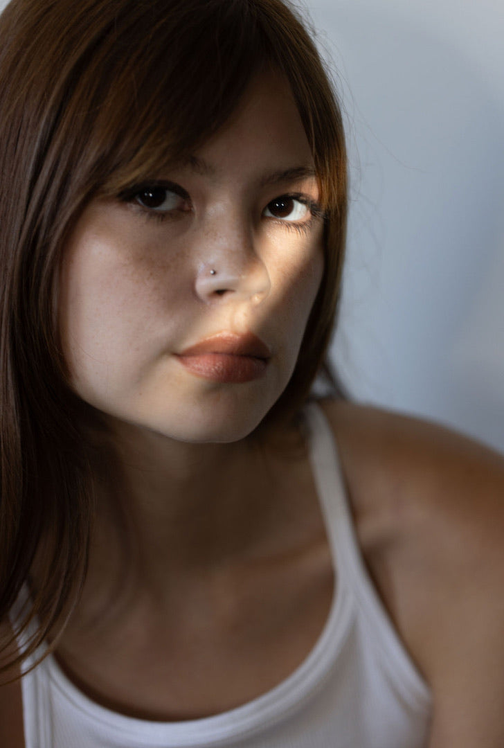 A beautiful woman with radiant, well-hydrated skin, representing the soothing and protective benefits of the Stay Clear skincare line for dry, sensitive skin in extreme climates.
